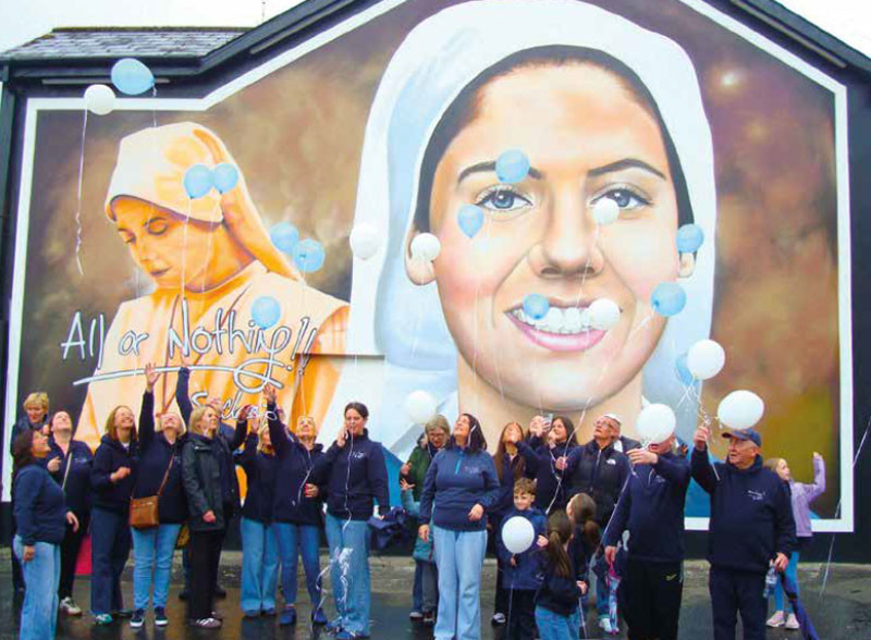 Crowd gathered at the blessing of the Sr Clare mural in the Brandywell, Derry, releasing balloons on the 10th anniversary of her death